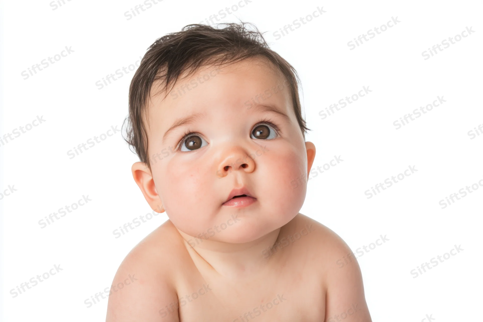 Close-up portrait of a baby with rosy cheeks and soft skin against white background