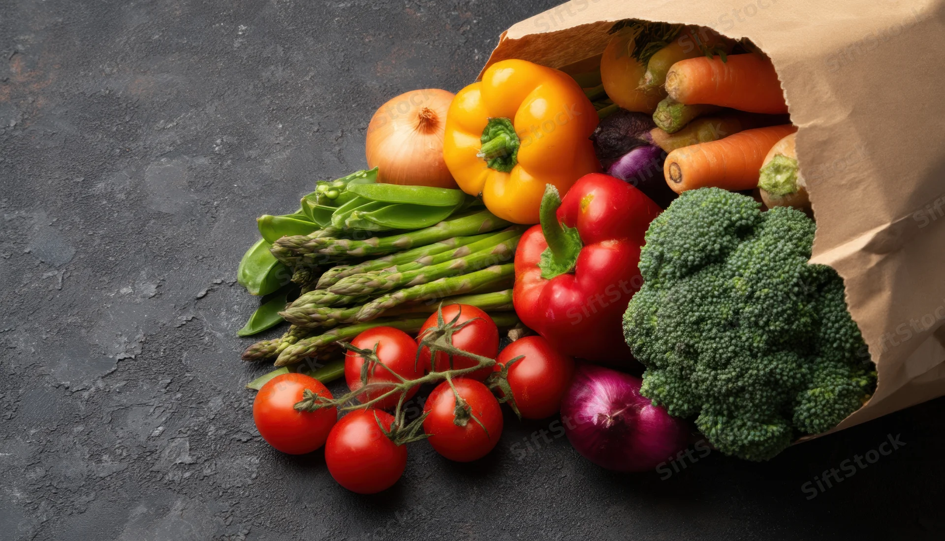 Fresh vegetables spilling from a paper bag on a dark countertop