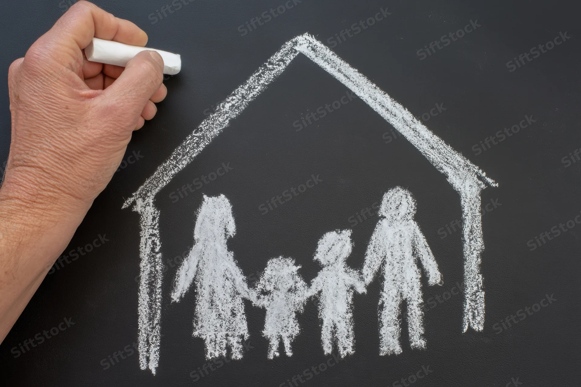 Hand drawing chalk sketch of family under house roof on blackboard