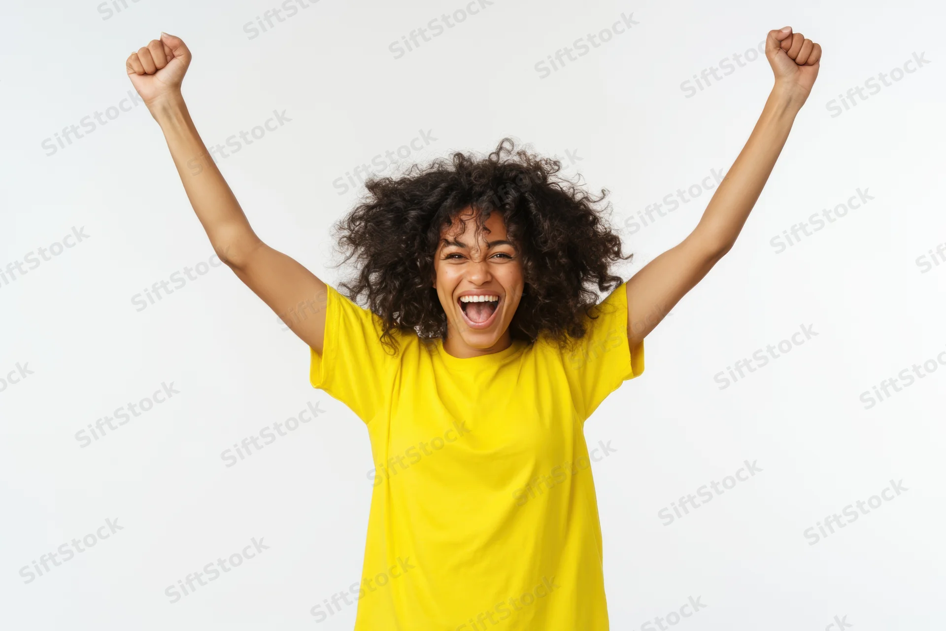 Woman celebrating with arms raised in victory wearing yellow tshirt against white background