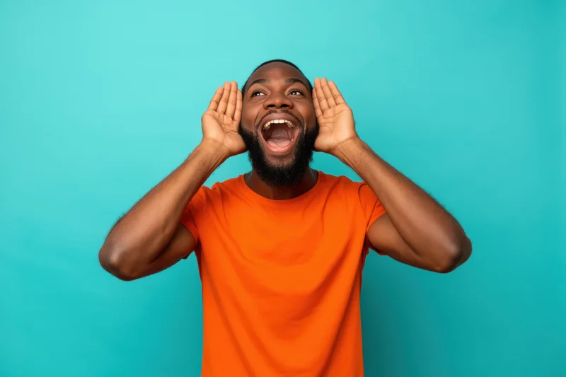 Man shouting with hands on ears against turquoise background