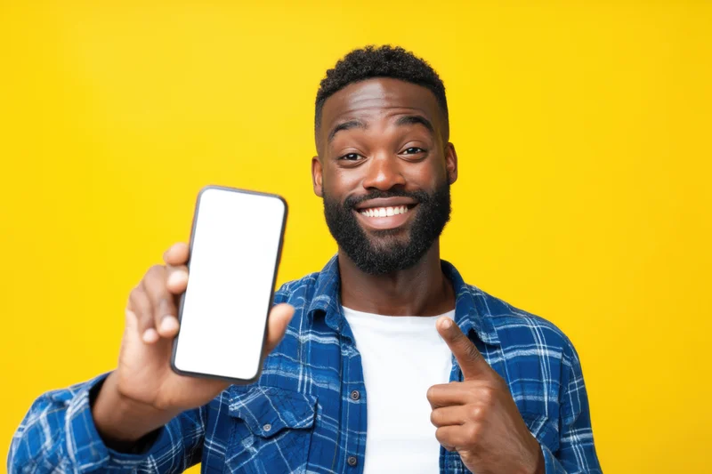 Joyful man with a trimmed beard wearing a blue plaid shirt
