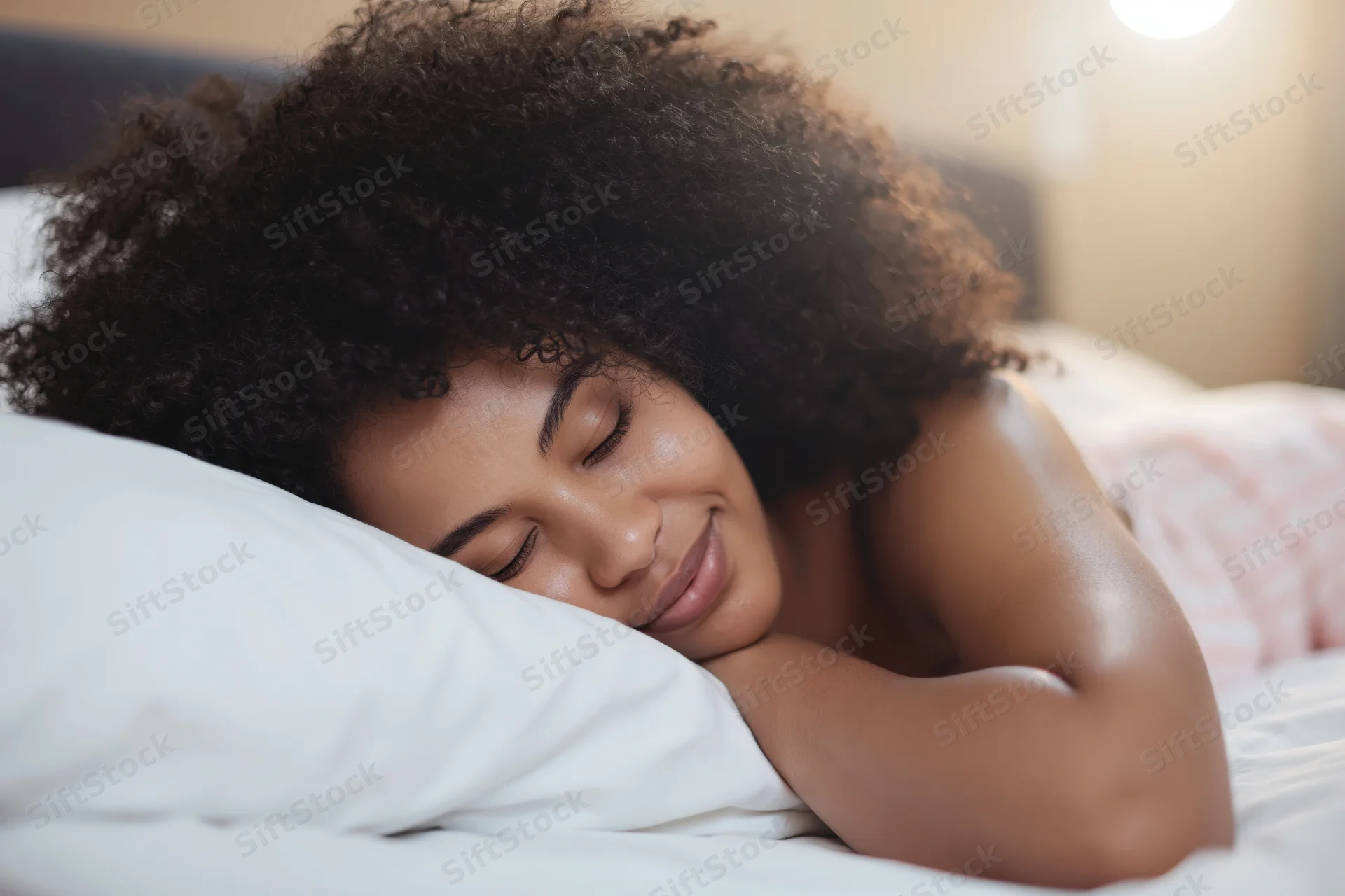Young black woman sleeping peacefully on a pillow in a cozy bedroom