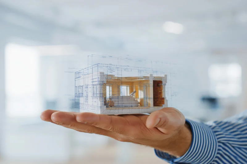 Man holding holographic architectural model in palm in office setting