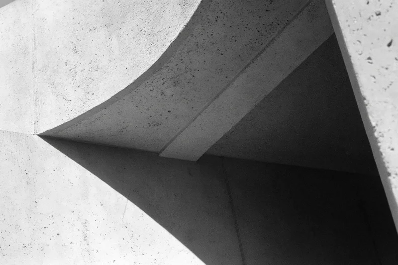 Abstract concrete architectural detail with intersecting angular forms and shadows