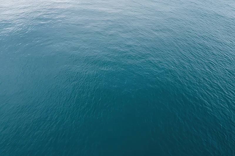Aerial top-down view of calm open water filling the frame