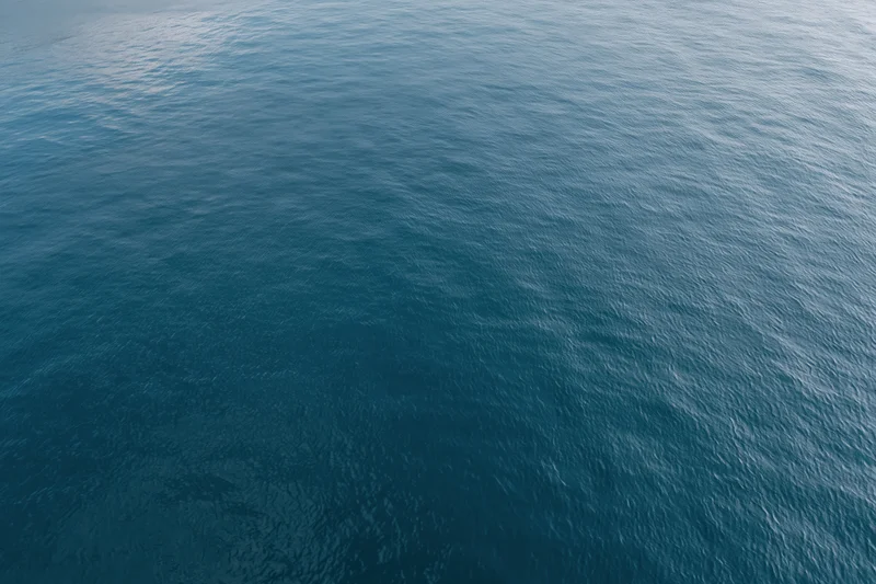 Aerial top-down view of calm open water surface