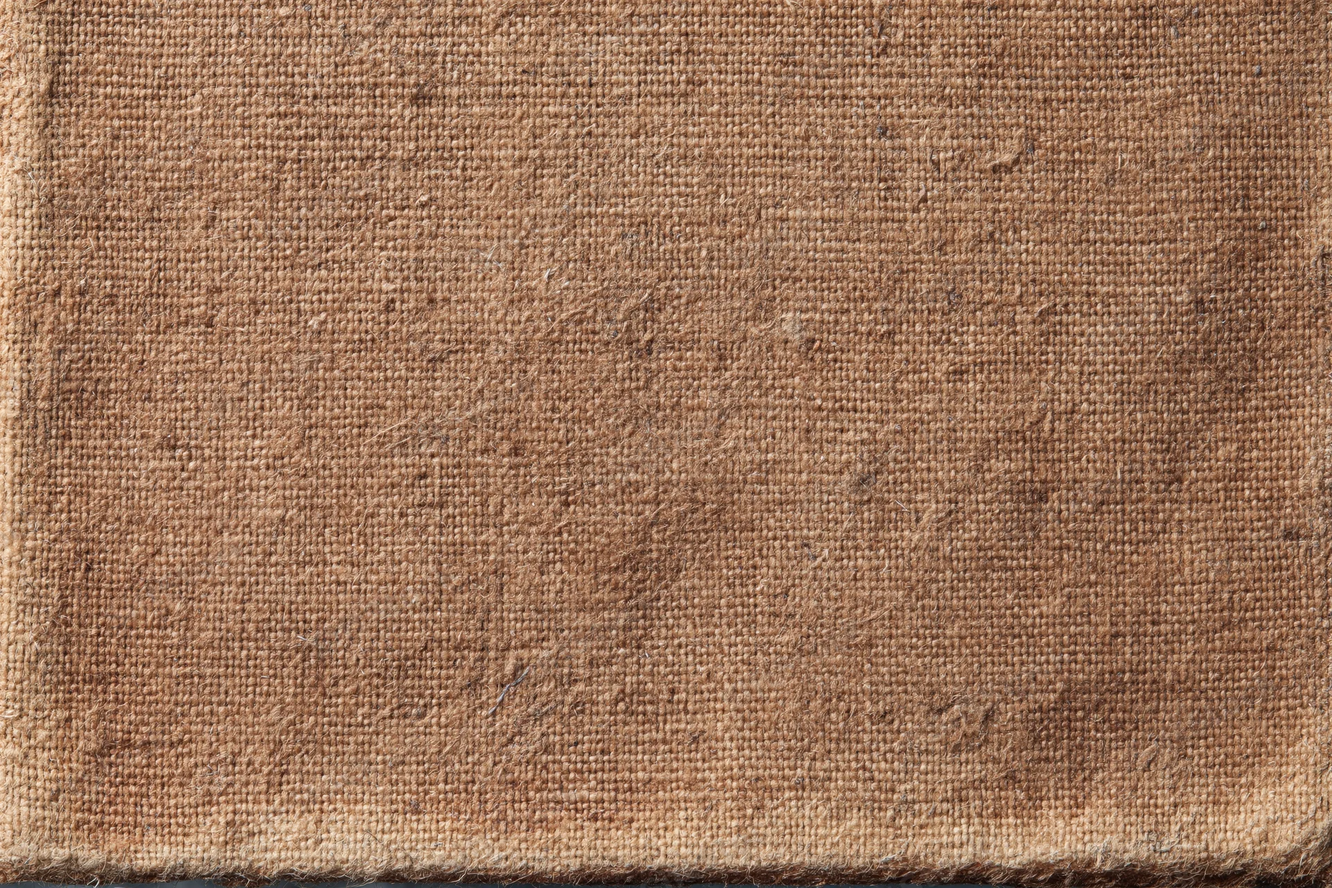 Closeup of worn brown canvas fabric with coarse weave and natural texture