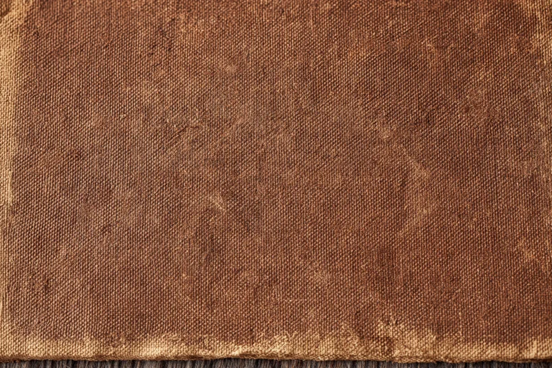 Close-up of aged brown canvas fabric with visible weave and wear marks