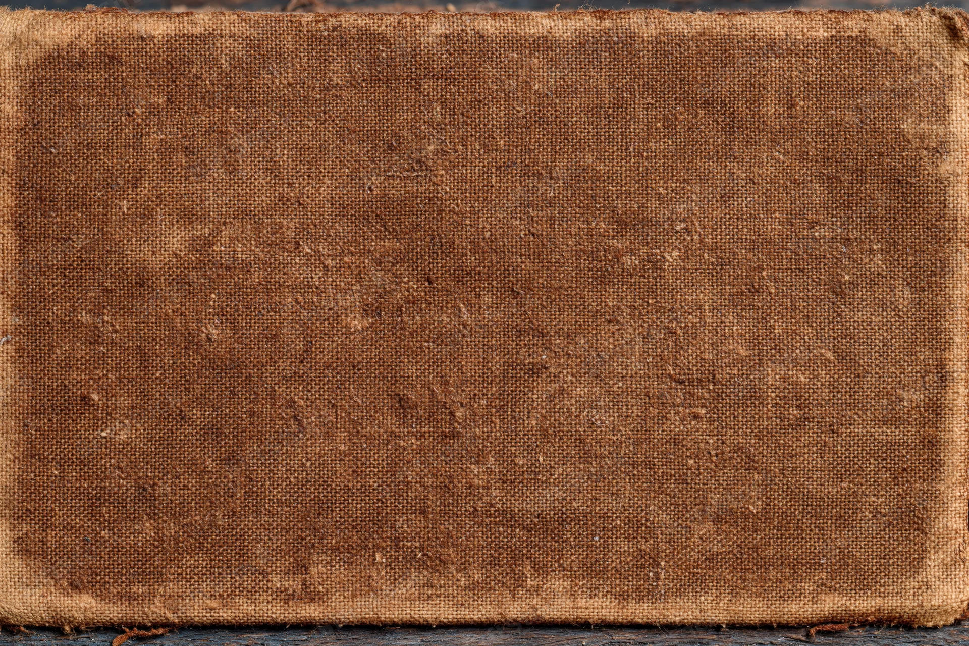 Worn canvas surface with coarse weave and aged texture, flat lay view