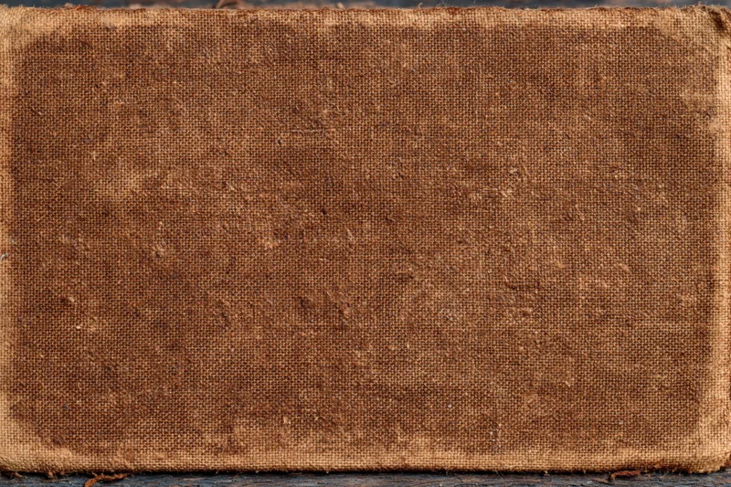 Worn canvas surface with coarse weave and aged texture, flat lay view