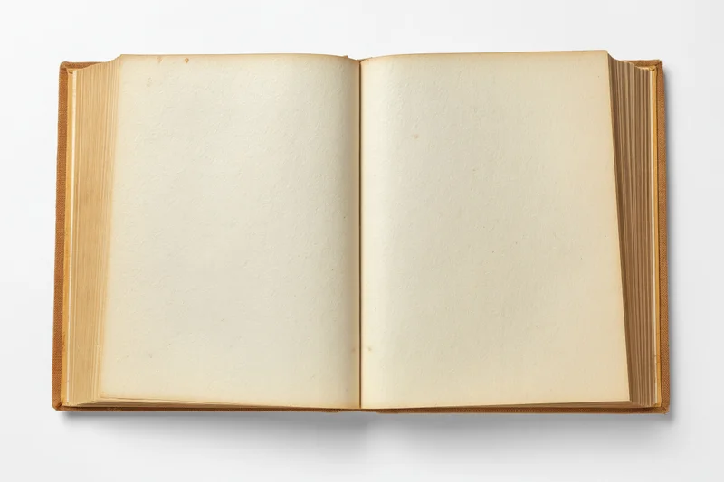 Open vintage hardcover book with blank yellowed pages on white background