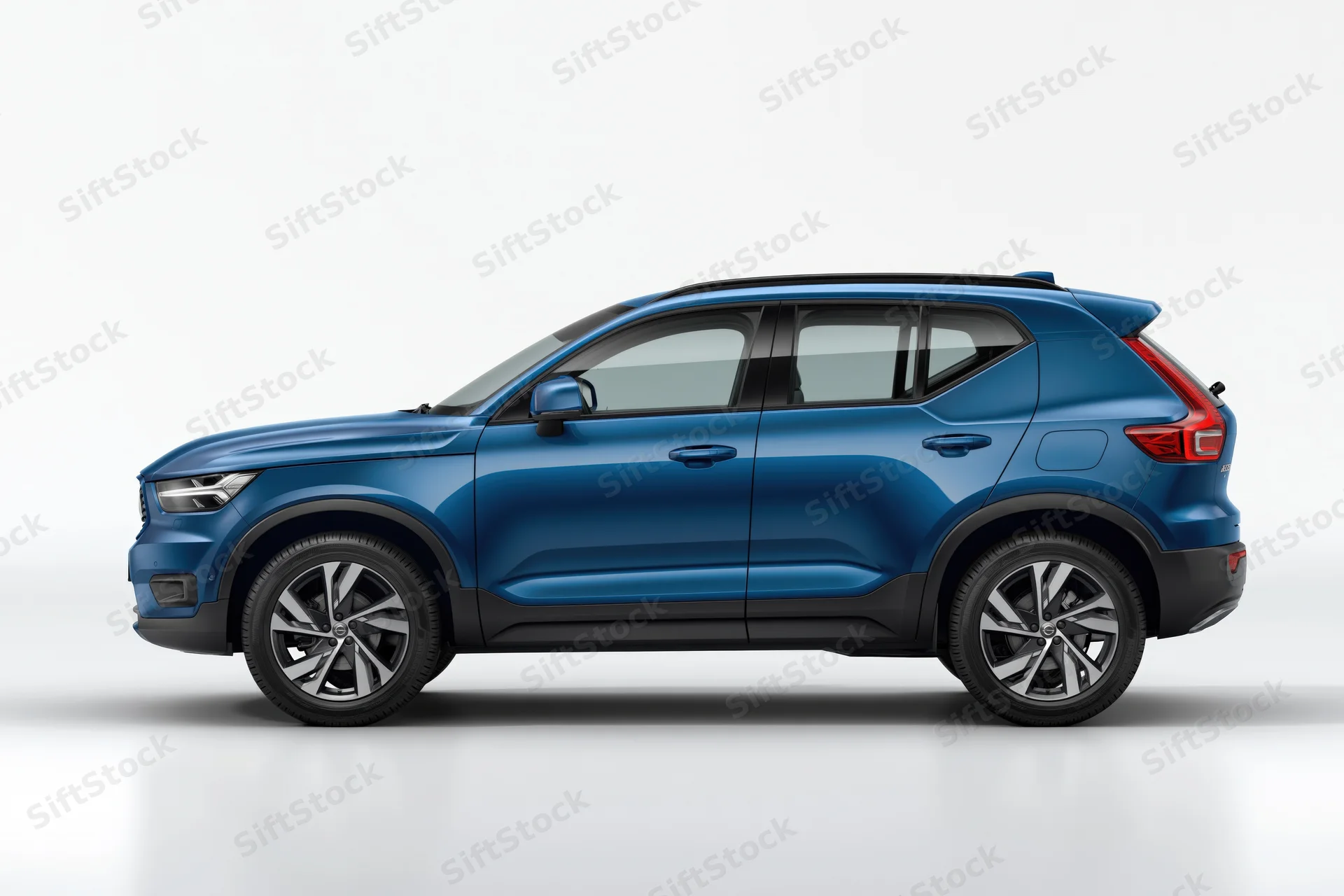 Blue compact suv in side profile view against white background