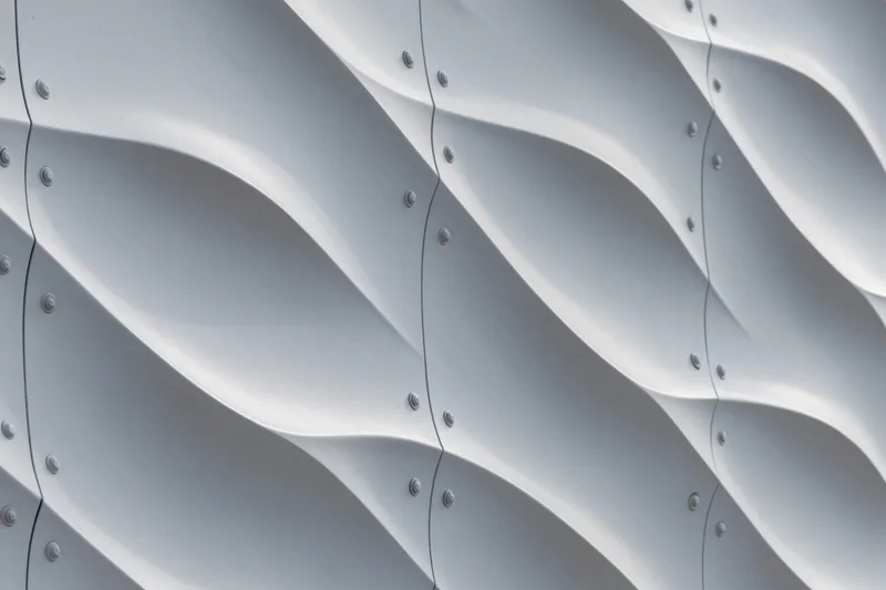 Close-up of wavy metal panels on a modern building facade