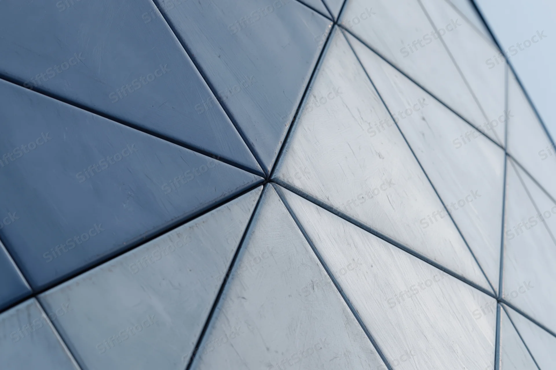 Close-up of triangular metal panels on a modern building facade