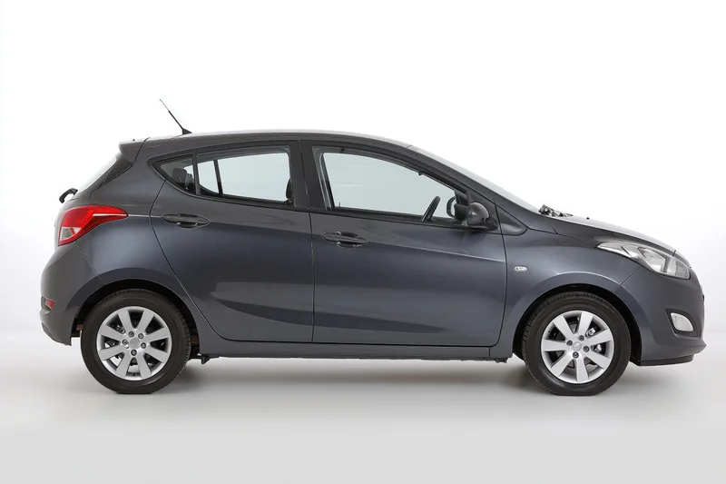 Dark grey compact hatchback in side profile against white background