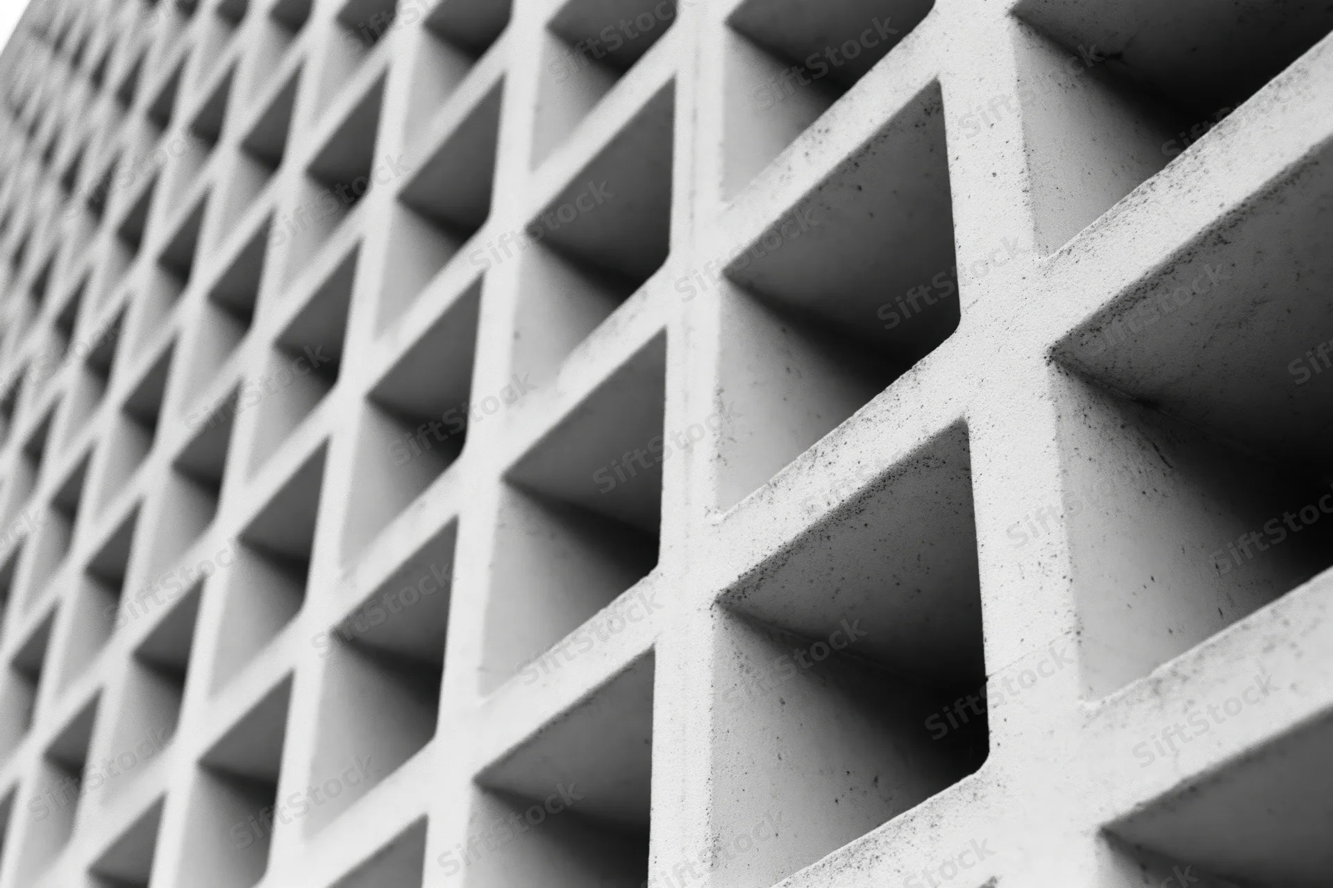 Close-up of a modernist concrete building facade with geometric grid pattern