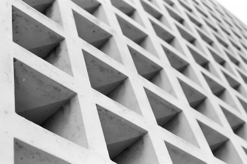 Close-up of a modernist concrete building facade with triangular geometric pattern