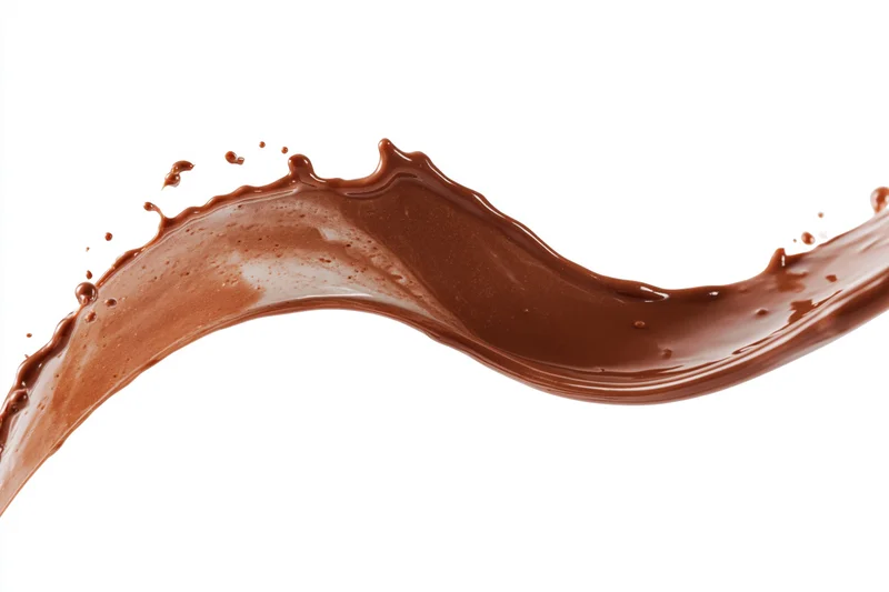 Liquid chocolate frozen mid-splash forming an arcing wave against white background