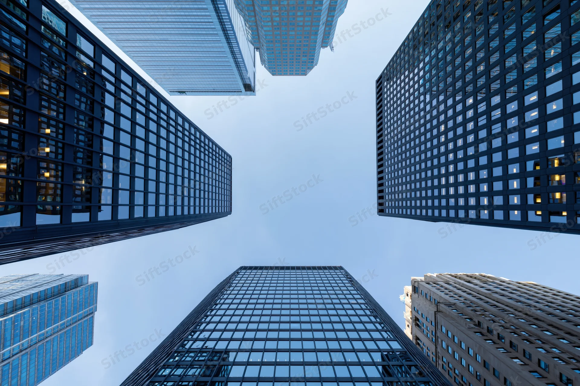 Low angle view of skyscrapers rising into the sky in a dense city center