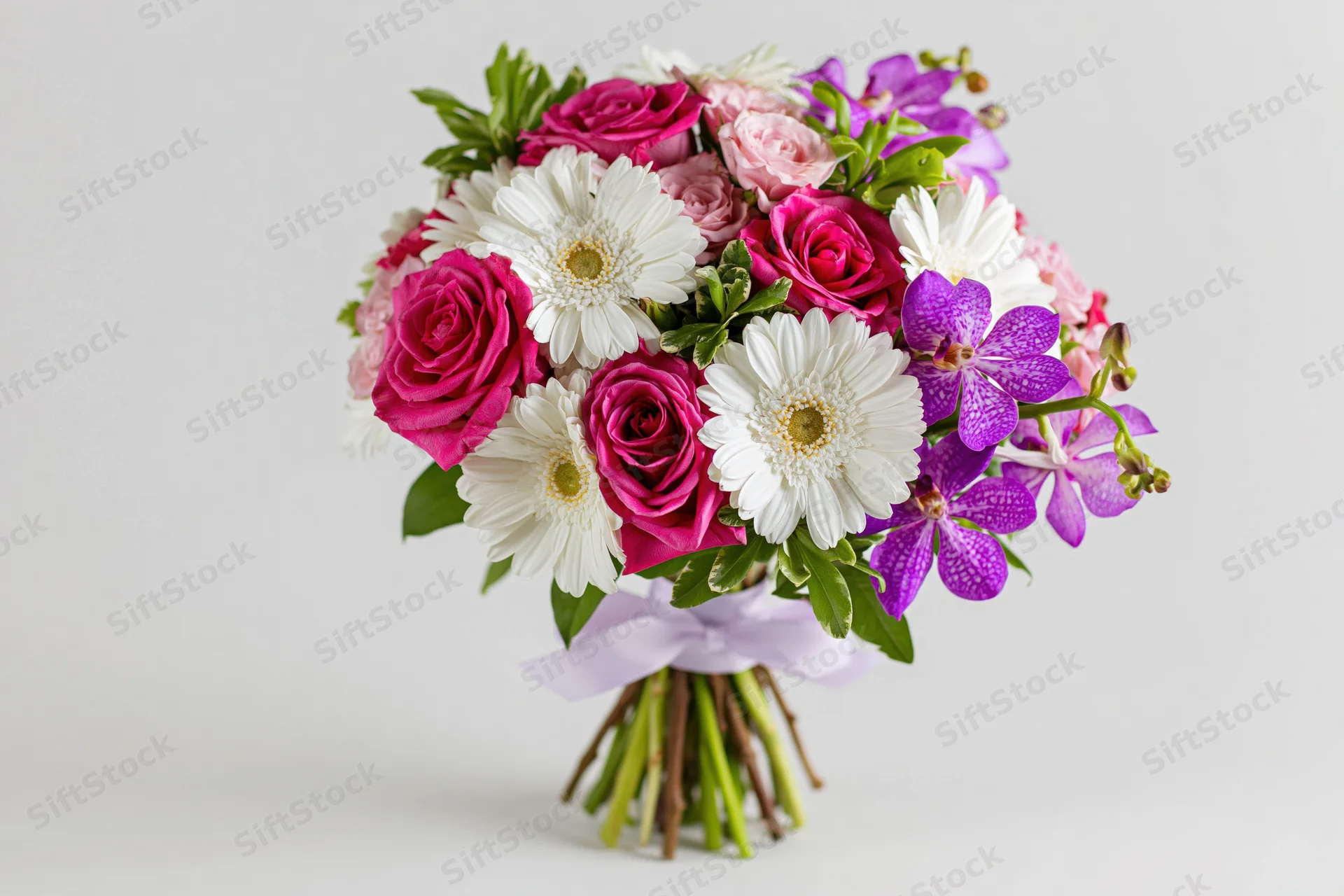 Mixed flower bouquet with pink roses, white gerbera, purple orchids, green stems tied with ribbon against white background