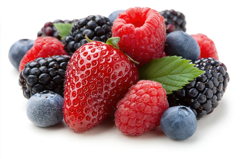 Mixed fresh berries including strawberry raspberry blueberry and blackberry arranged in a loose pile on white background