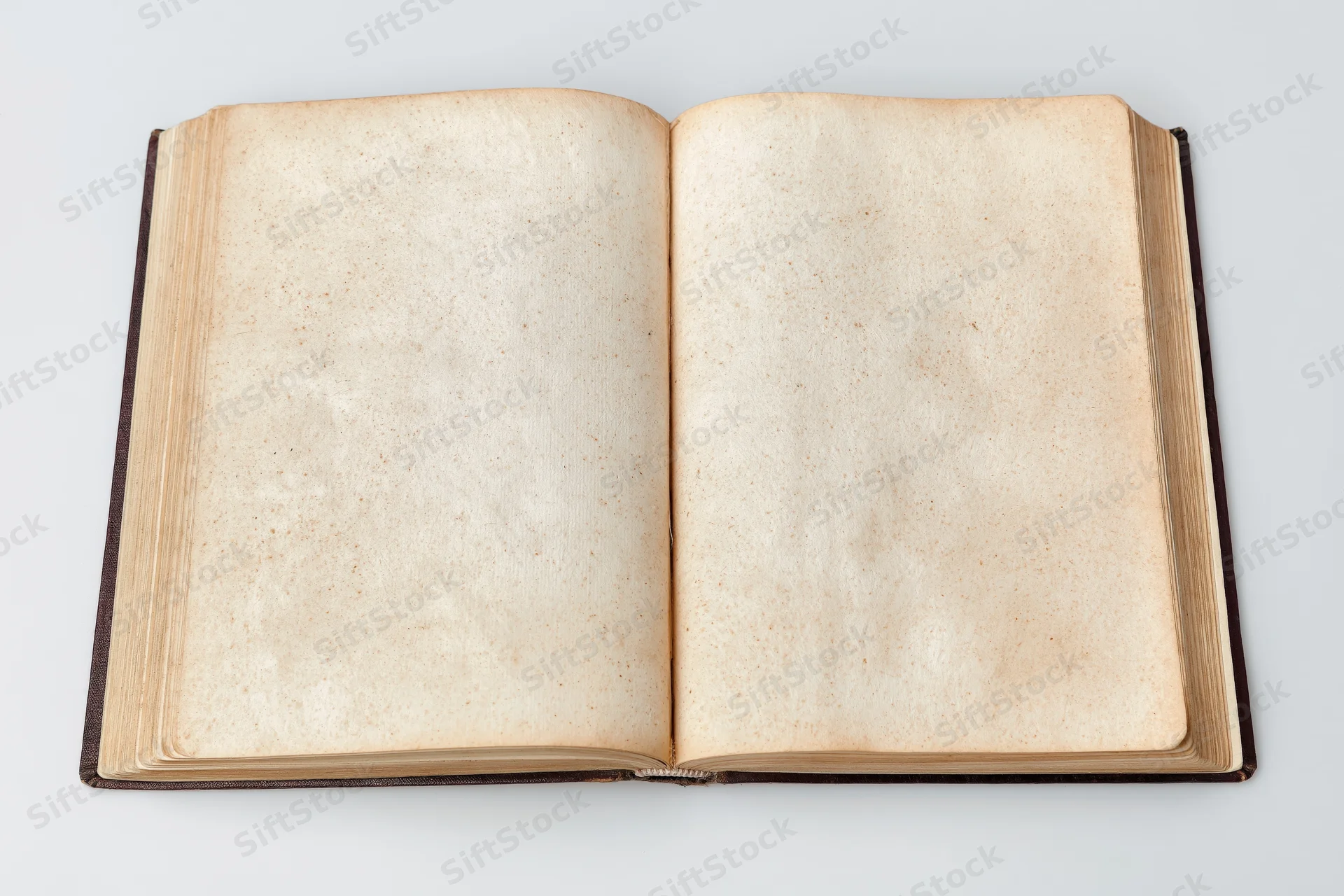 Open vintage hardcover book with blank aged pages on white background