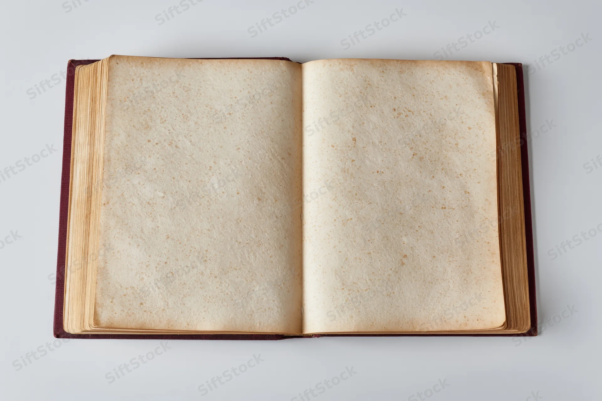Open hardcover book with blank aged pages on white background