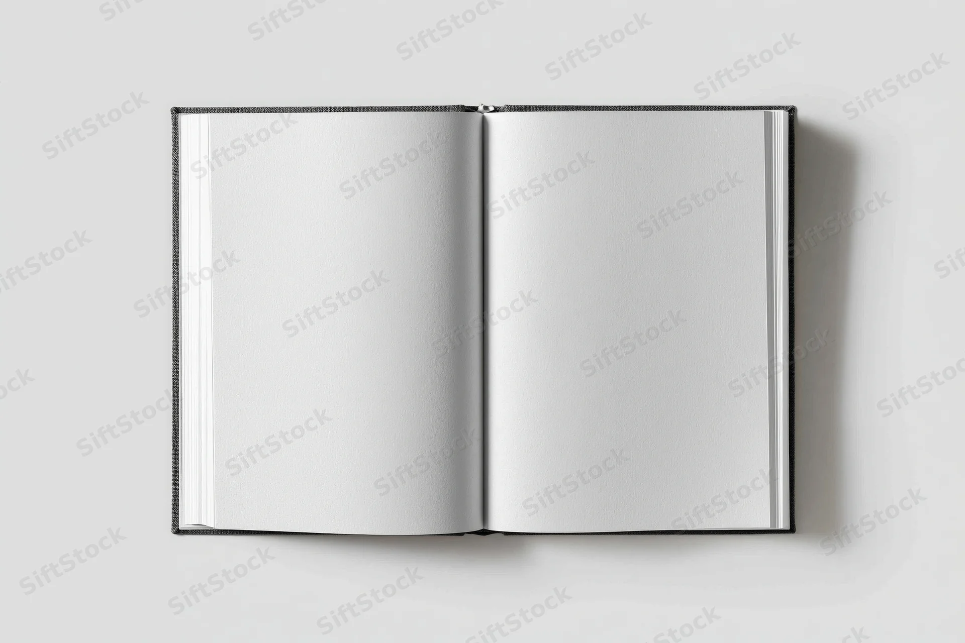 Open hardcover book with blank white pages lying flat on a neutral surface
