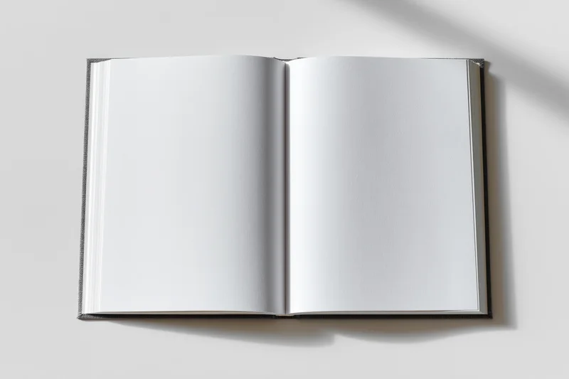 Open hardcover book with blank white pages lying flat on a white surface