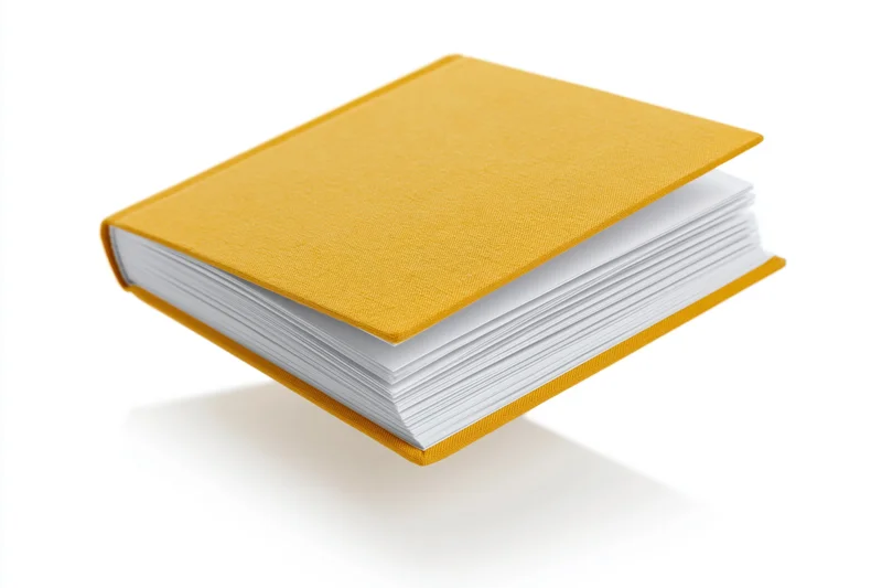 Open hardcover book with mustard yellow cloth cover floating on white background