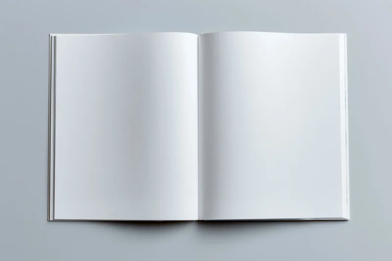 Open book with blank white pages lying flat on gray surface