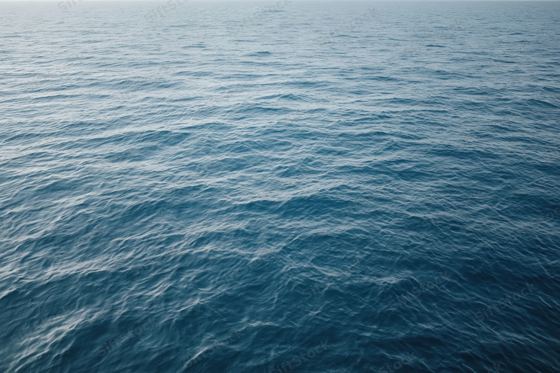 Aerial view of open ocean surface with gentle waves and no visible horizon