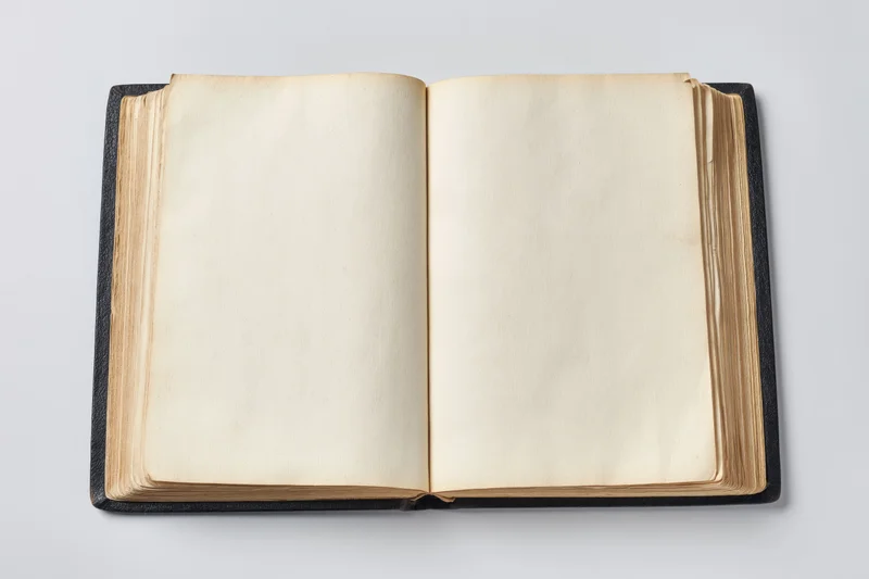 Open vintage hardcover book with blank cream pages on white background