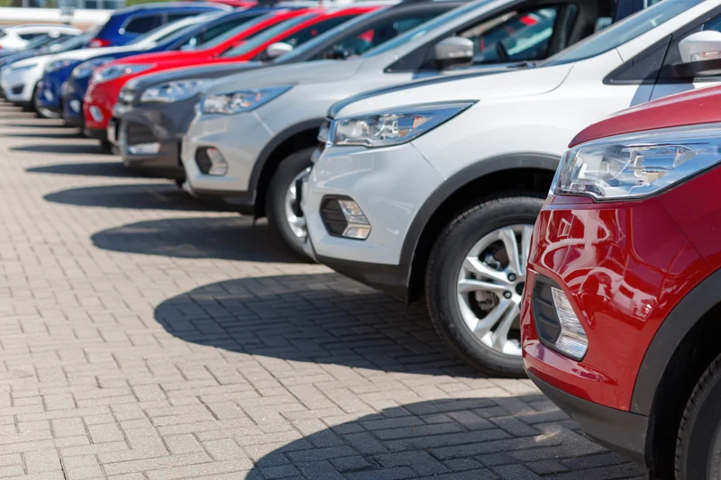 Row of suvs and crossovers parked diagonally in a dealership lot