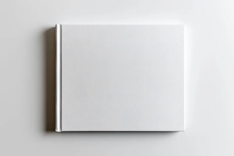 Square hardcover book with blank white cover lying flat on white surface
