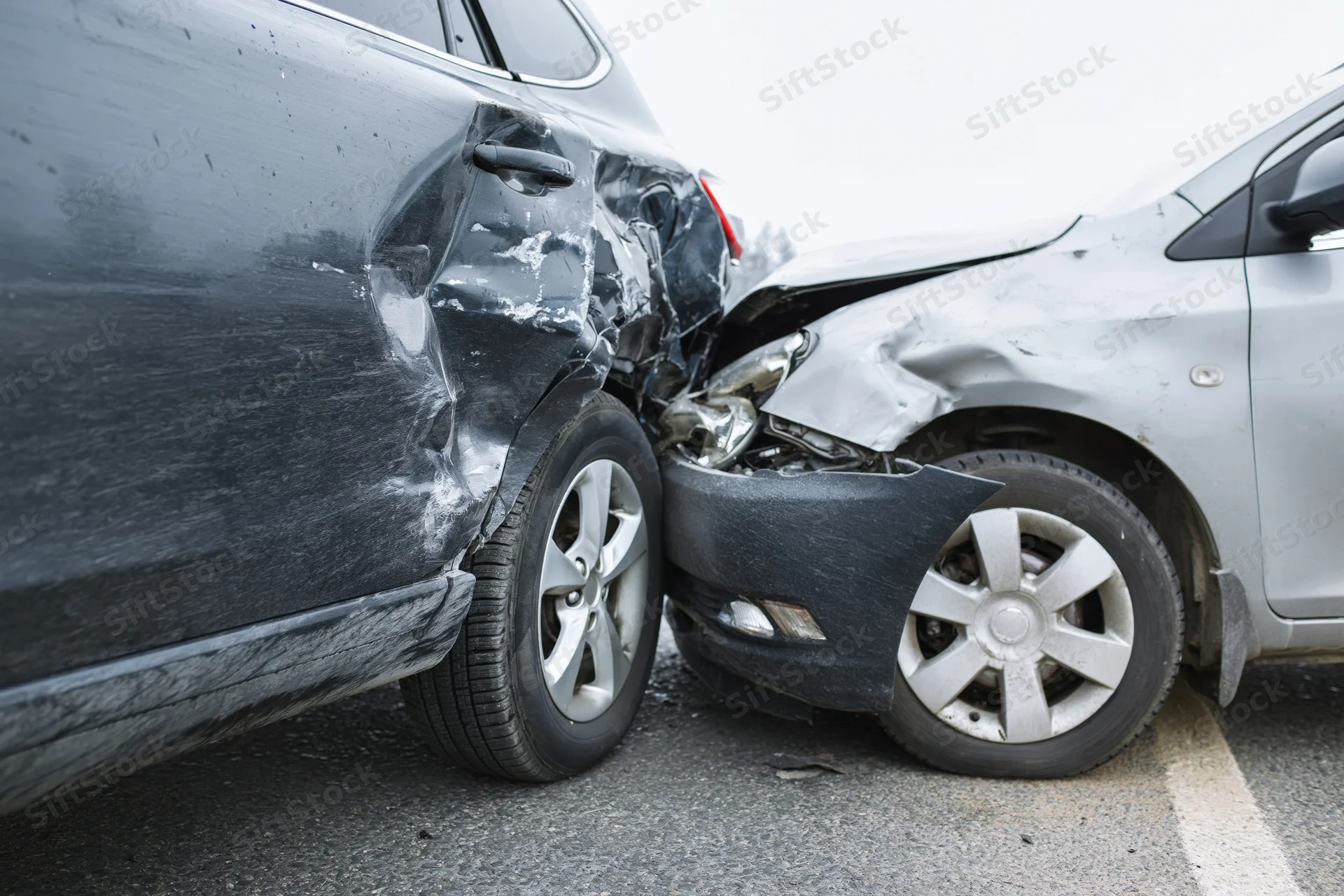 Two damaged cars after a rear-end collision on a road