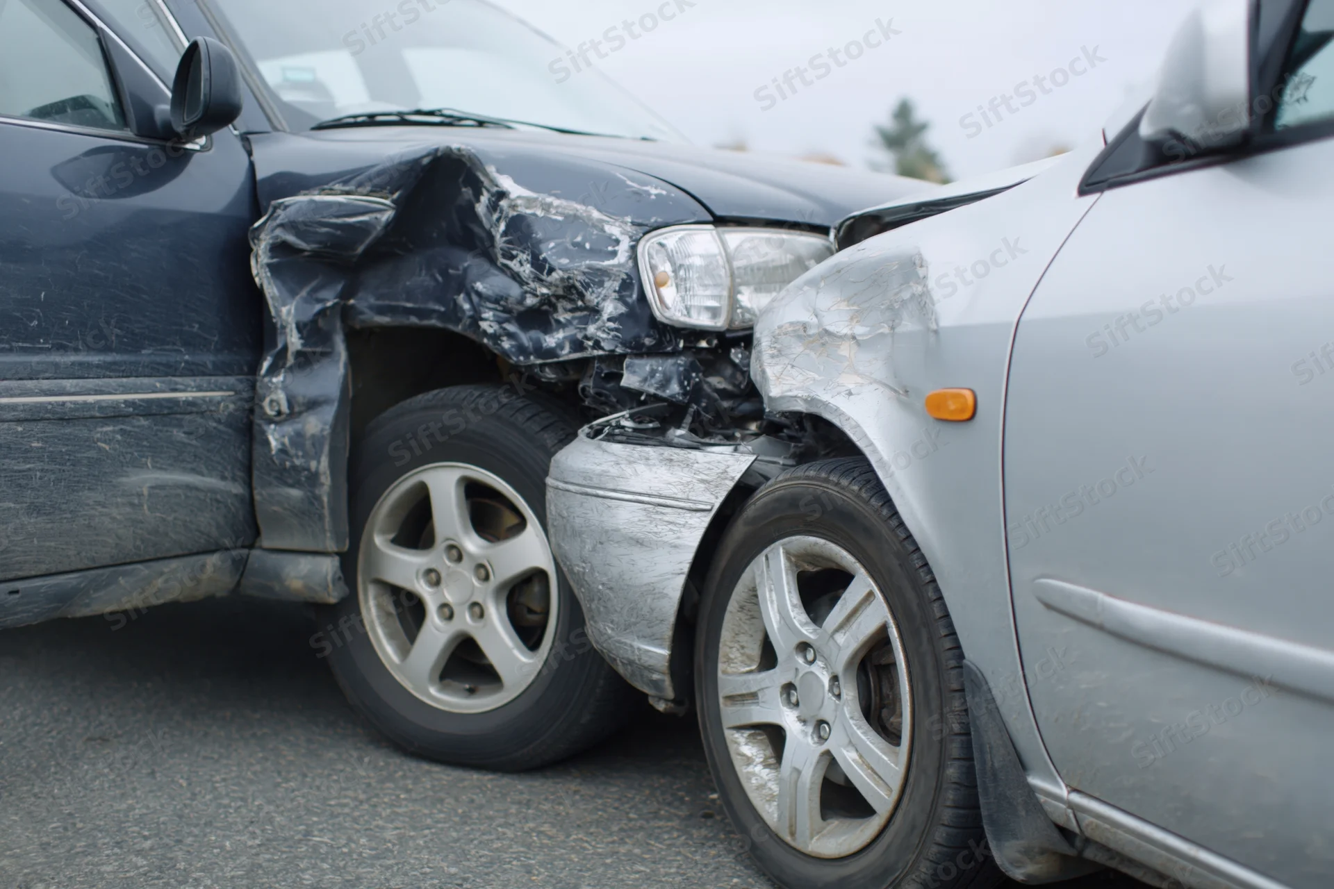 Two damaged cars after a rear-end collision on a road