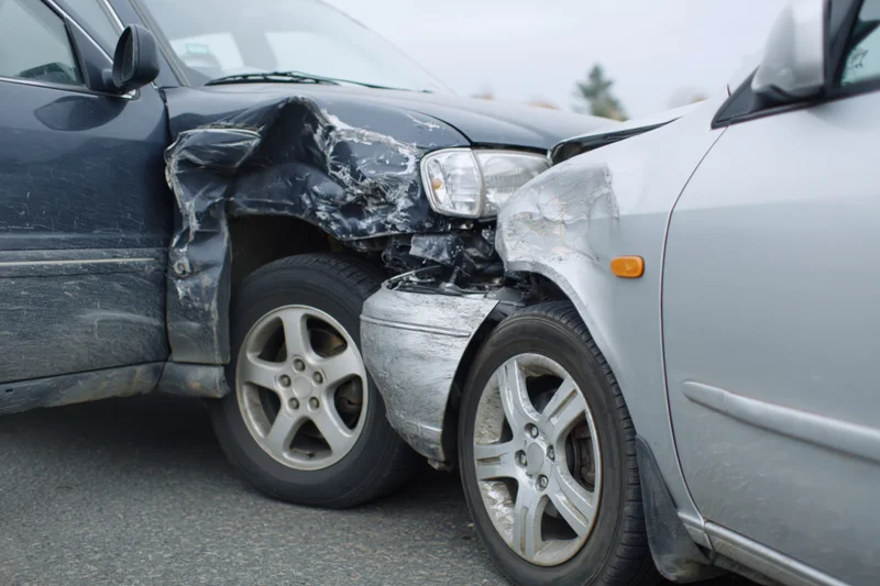 Two damaged cars after a rear-end collision on a road
