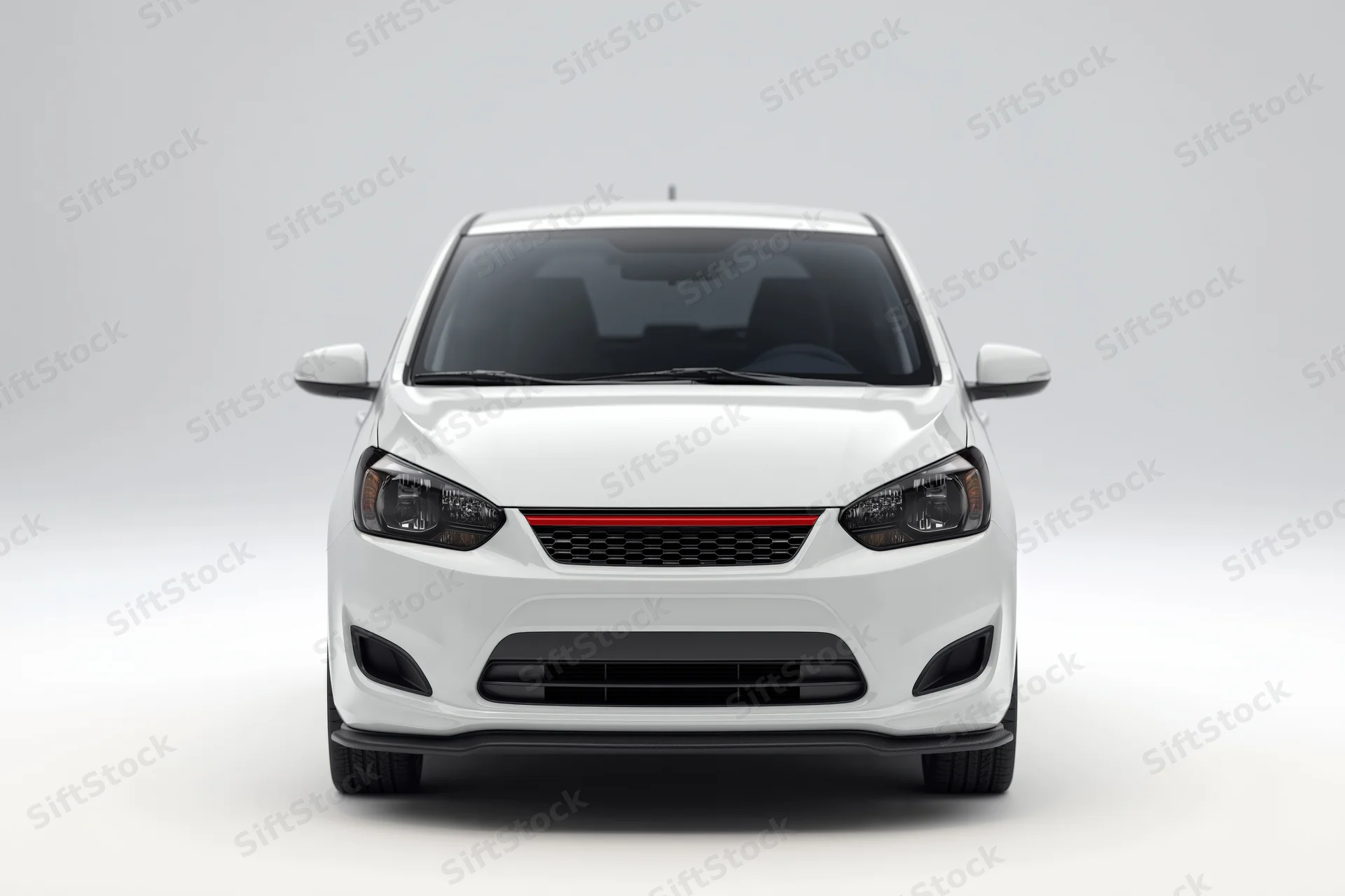 White compact hatchback viewed straight-on from front in studio setting