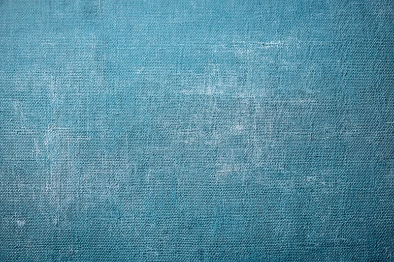 Worn teal-painted canvas texture filling the entire frame
