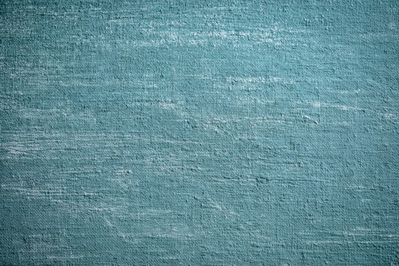 Worn teal-painted canvas texture filling the frame
