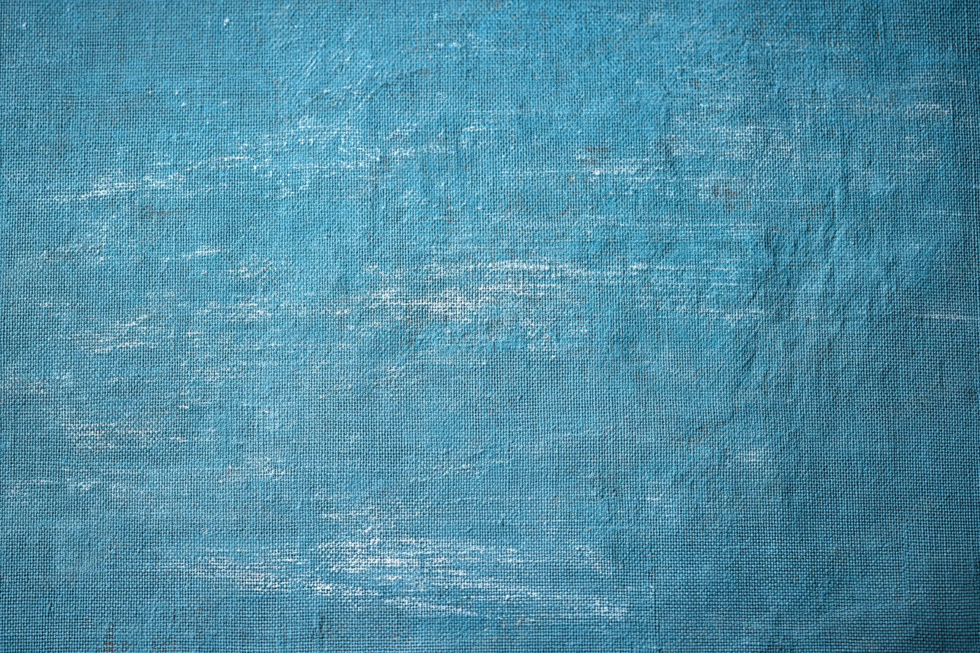Worn teal-painted canvas texture filling the frame
