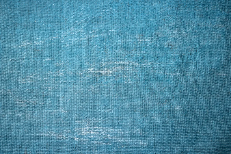 Worn teal-painted canvas texture filling the frame