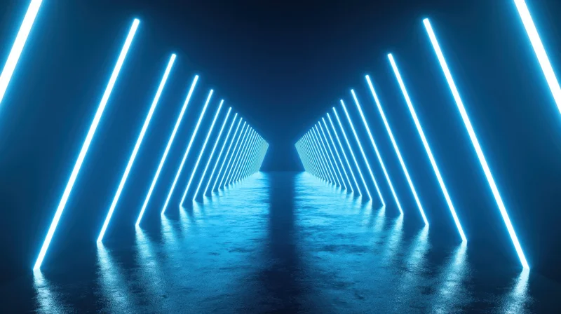 Symmetrical futuristic tunnel with glowing blue neon lights lining dark corridor and reflective wet floor