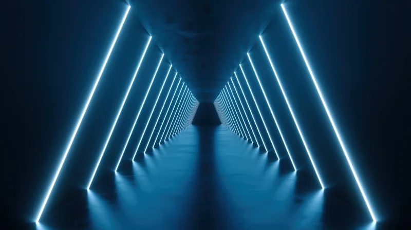 Symmetrical futuristic tunnel illuminated by blue neon lights receding into the distance