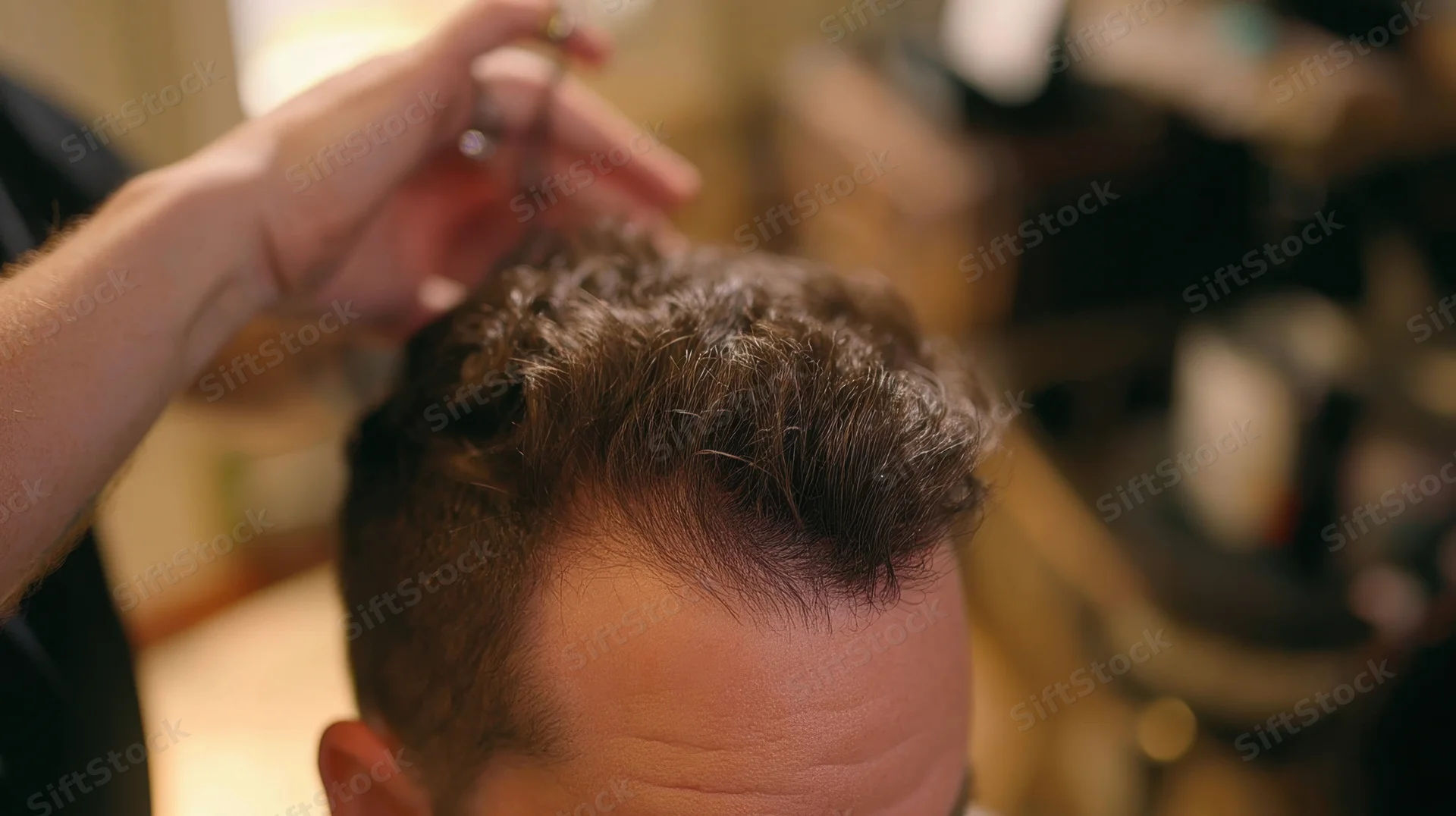 Barber styling a man's hair in a salon