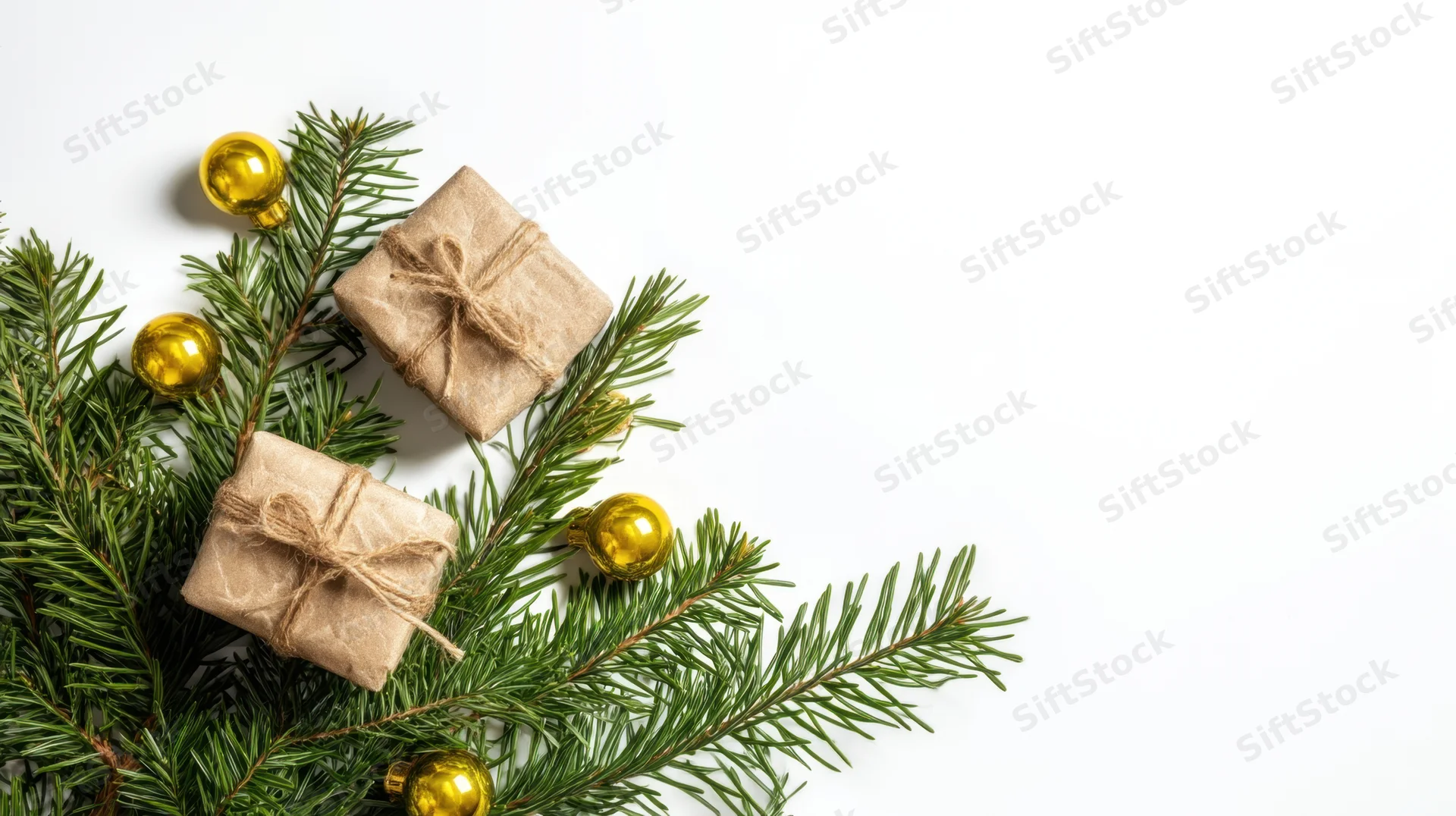 Evergreen branches with wrapped gifts and gold ornaments arranged on white surface