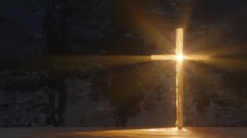 Glowing cross illuminated by golden light against a dark stone background