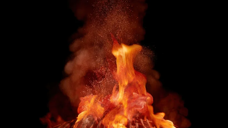Intense flames and smoke rising against a black background